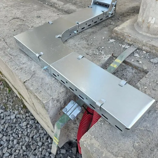 Pozinkovaný kabelový žlab navazující na chráničky v zemi